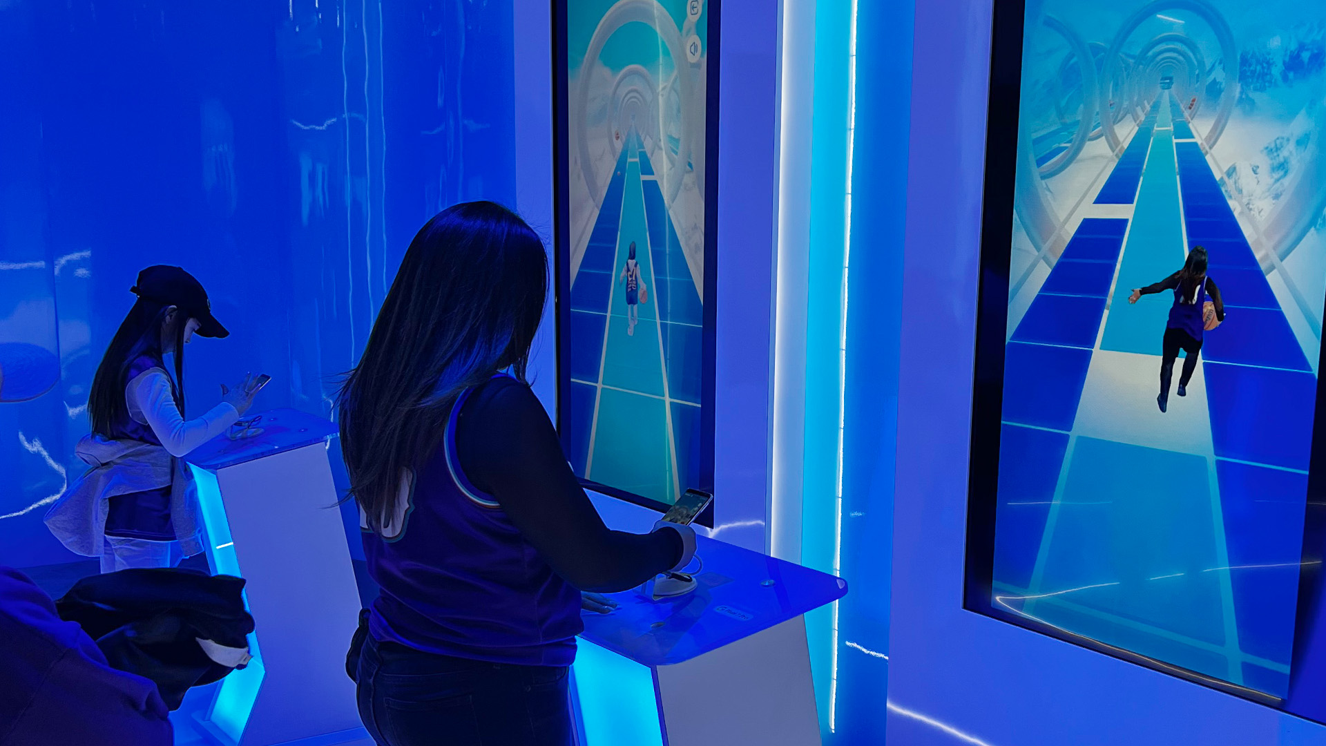 Two fans playing Dribble Dash against each other in the AT&T NBA All-Star Playmaker Arcade.