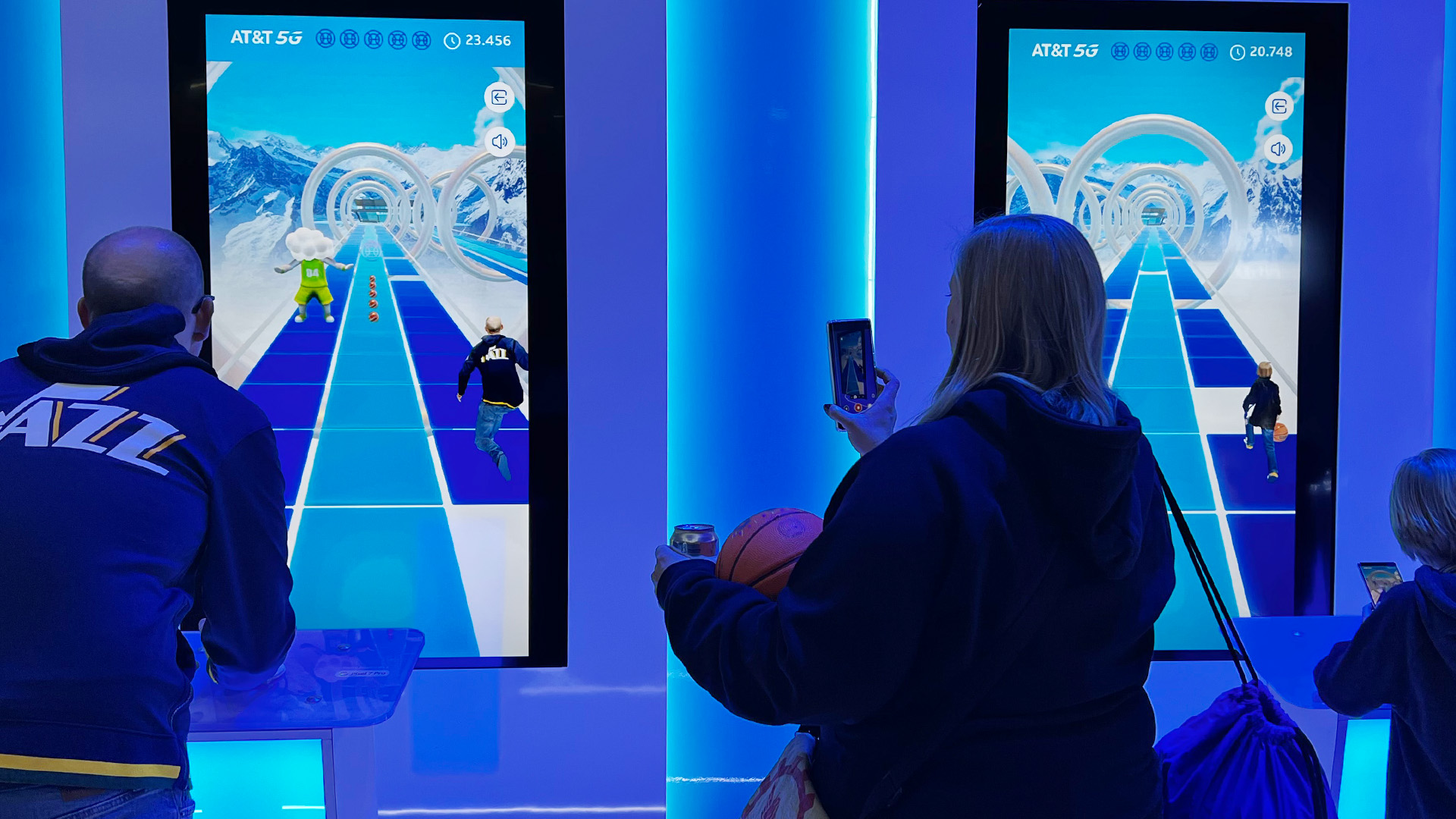 Two fans playing Dribble Dash against each other in the AT&T NBA All-Star Playmaker Arcade.